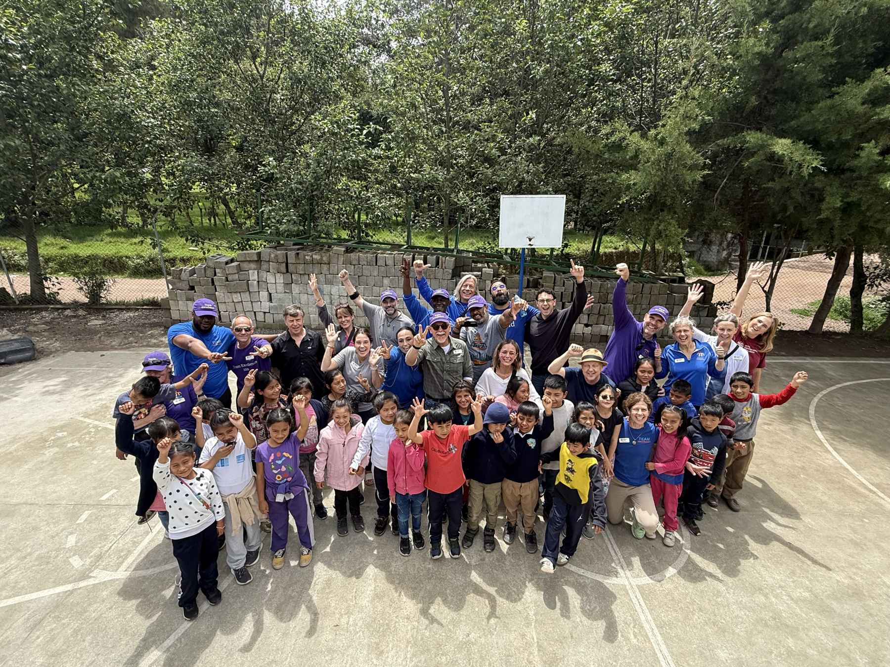 Students and volunteers gathered outside a school supported by the family