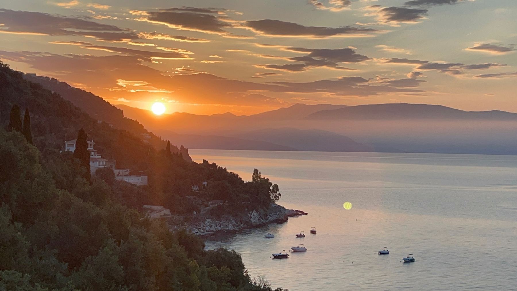 Sunset over the coast of Corfu, Greece — the 2026 family retreat