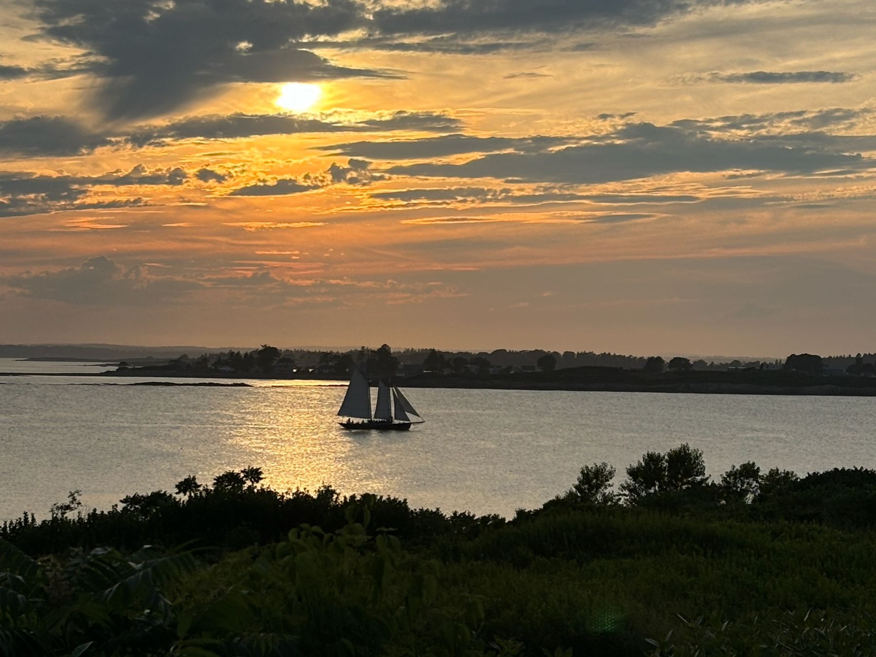 A sailboat at sunset off Bailey Island, Maine